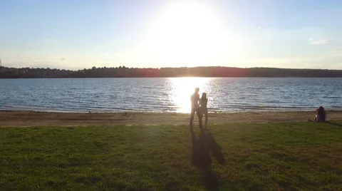 Couple walking on the pier at sunset. Shooting with quadrocopters. Dron. dji Stock Footage 67486268