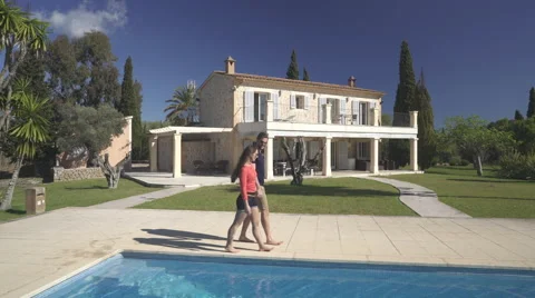 Couple walking on poolside Stock Footage 62697406