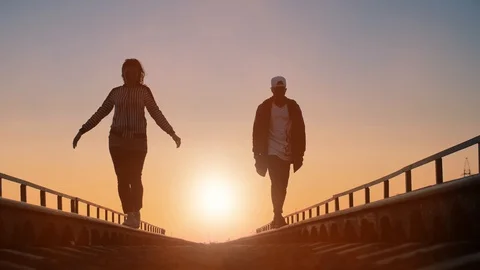 Couple walking by railway Stock Footage 89700662