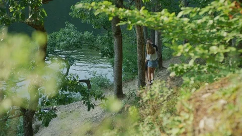 Couple walking by a river Stock Footage 99968188