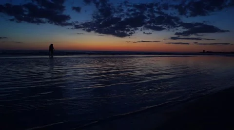 Couple Walking on Sand Bar at Sunset silhouette Video stock 62811980