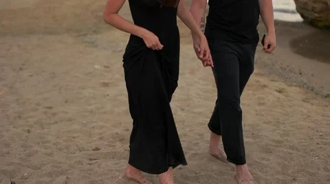 Couple walking on the sand Stock Footage 65293116