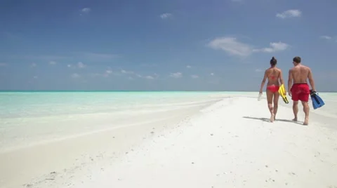 Couple walking on sandbar Stock Footage 10788676