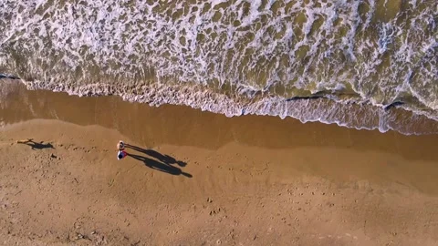 Couple walking on sandy beach with waves Video stock 330668479