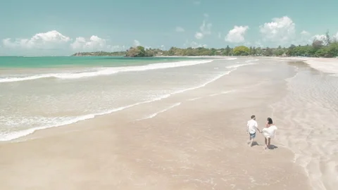 Couple Walking On A Sandy White Sandy Beach Stock Footage 248586731