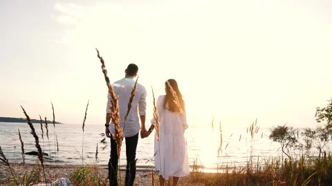 Couple walking on shores Stock Footage 137750748