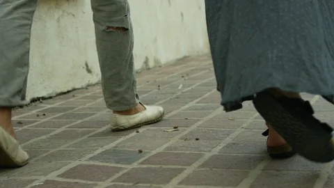 Couple walking on sidewalk Stock Footage 106333743