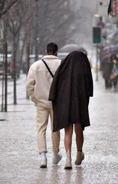 Couple walking on the sidewalk Stock Photos