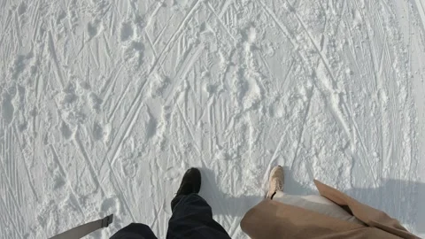 A couple is walking on a snow-covered ground Stock Footage 313597732