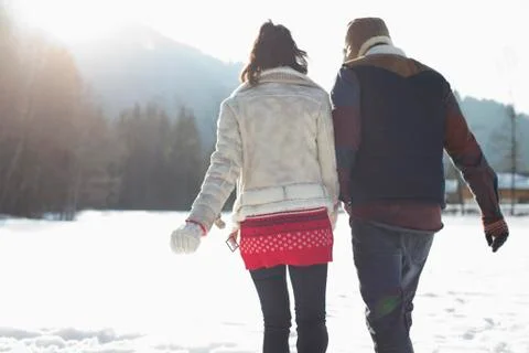 Couple walking in snow Stock Photos