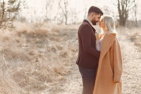 Couple walking in a spring field Stock Photos