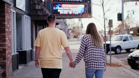 Couple walking on the street Stock Footage 100986294