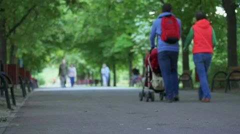Couple walking with stroller and small child. Stock-Footage 66368652