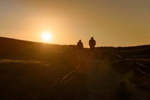 Couple walking in the sunlight Stock Photos