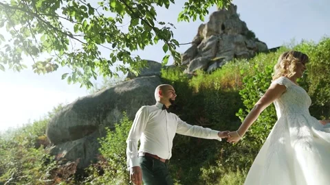 Couple walking through the amazing cliffs view they have a chill time. Slowmo Stock Footage 221017442