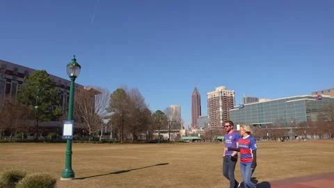 Couple walking through Centennial Olympic Park in Atlanta Georgia man and wom Stock Footage 147619228