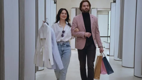Couple walking through changing rooms in shopping mall Stockbeeldmateriaal 311873344