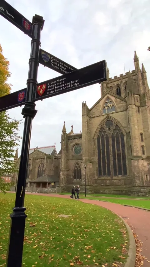 A couple walking through empty streets near Hereford cathedral Stock Footage 167218803