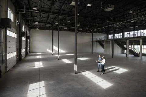 Couple walking through empty warehouse Stock Photos