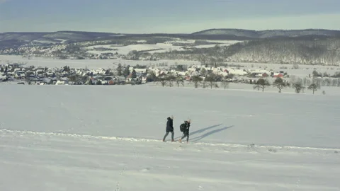 Couple walking through snow Stock Footage 148630609