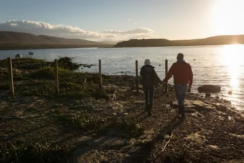 Couple walking together while holding hands 写真素材