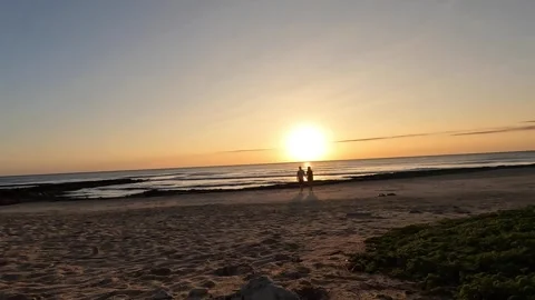 Couple Walking Towards the Camera with the Sun Rising in the Background 動画素材 278495008