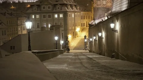 Couple Walking Under a Heavy Snowfall in a Street of Prague in Winter at Night Stock-Footage 72030020