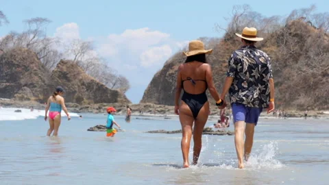 Couple walking on white sand beach in the Caribbean Stock Footage 122348276