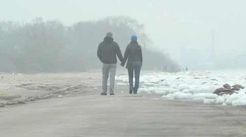 Couple walking at winter seaside, ice around, cold weather Video stock 10834207