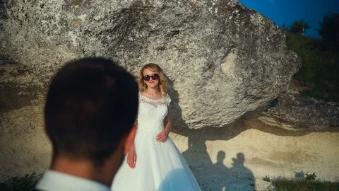 Couple walks out to ocean cliffs, takes in view together. Slow motion Stock Footage 107808709