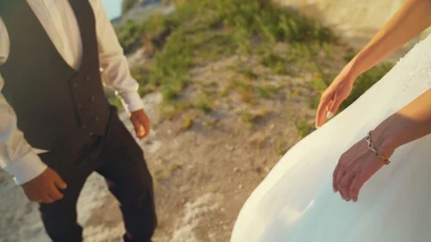 Couple walks out to ocean cliffs, takes in view together. Slow motion Stock Footage 107808913