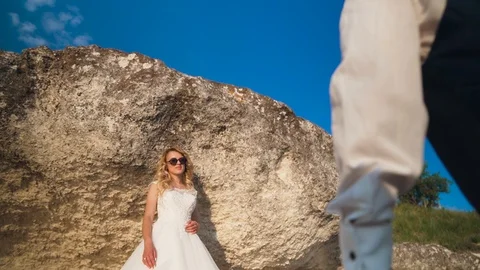 Couple walks out to ocean cliffs, takes in view together. Slow motion Stock Footage 107809105