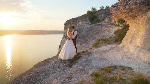 Couple walks out to ocean cliffs, takes in view together. Slow motion. Stock Footage 107814072