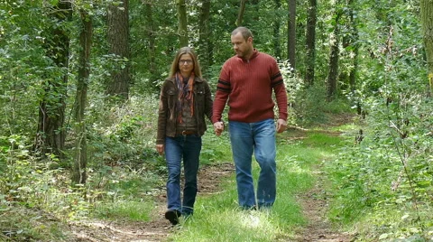A couple walks in the woods Stock Footage 54574284