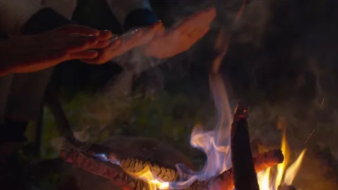 Couple warming hands on the bonfire Stock Footage 130864175