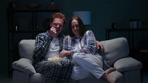 A couple watch comedy on the sofa Stock Footage 166097998