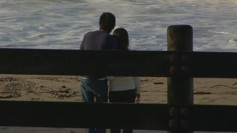 Couple watching big waves on beach in Laguna Beach, California USA Stock Footage 101265415