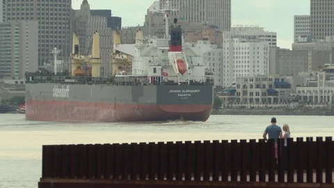 Couple watching cargo ship sailing in sea Stock Footage 84512736