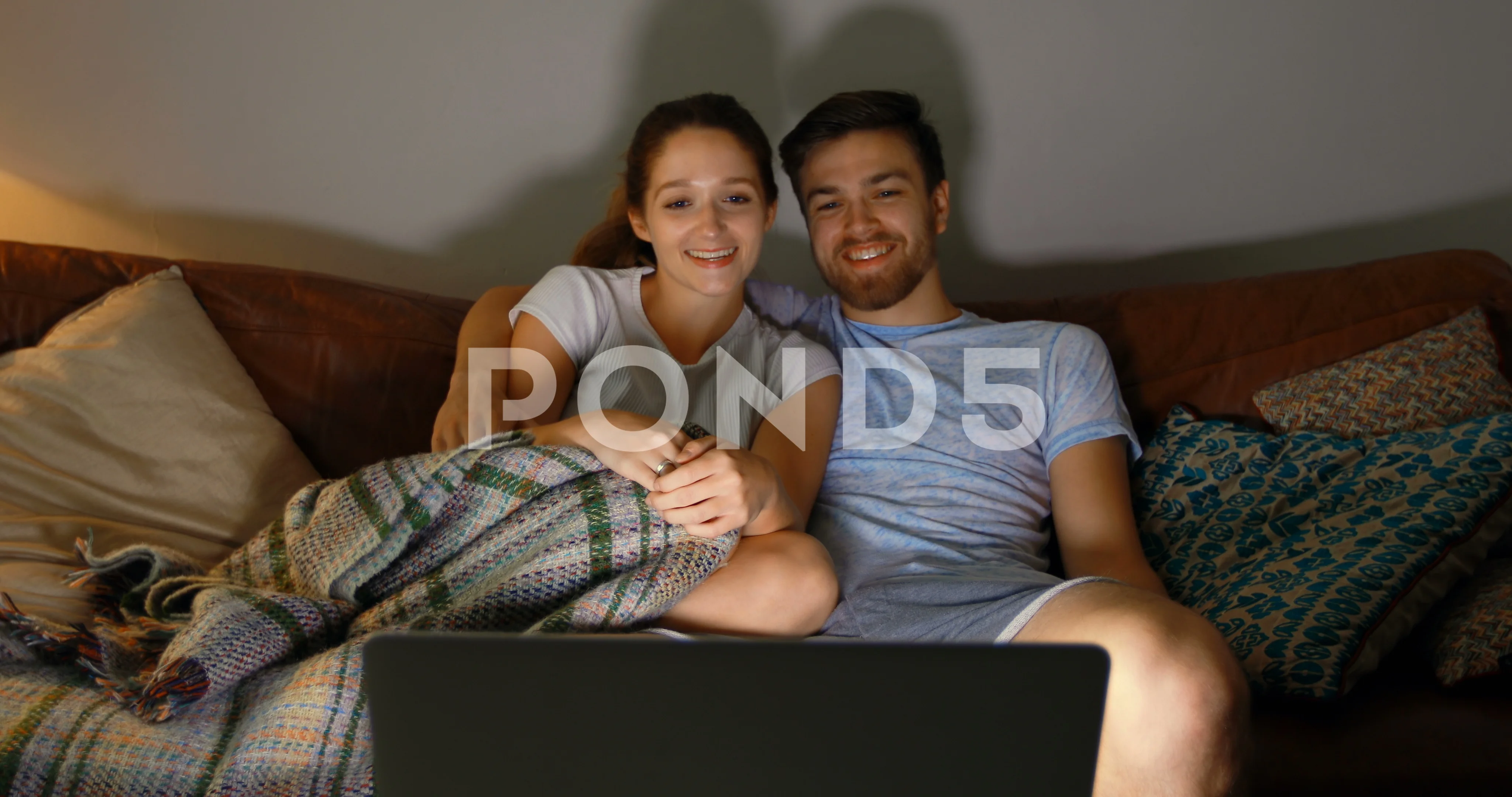 Couple watching movie on laptop at home 4k