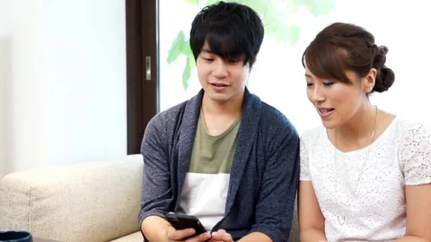 Couple watching smartphone Stock Footage 72610760
