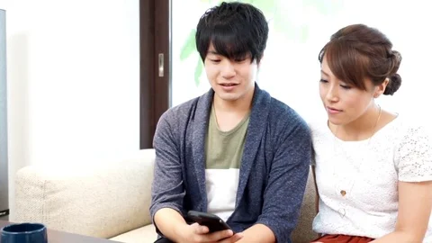 Couple watching smartphone Stock Footage 72616023