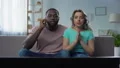 Couple watching sports match on tv home, celebrating victory, successful game 4k or 4k+ Resolution