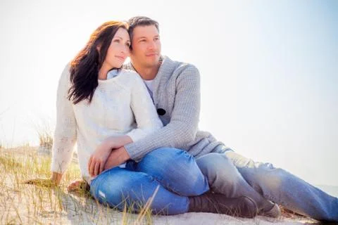 Couple watching the sun fall down Stock Photos