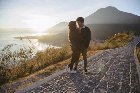 Couple watching the sunrise at Lake Atitlán - Travelers in Guatemala Stock Photos