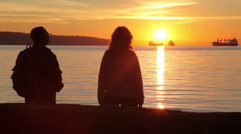 Couple watching sunset at the beach 03 Stock Footage 30248904