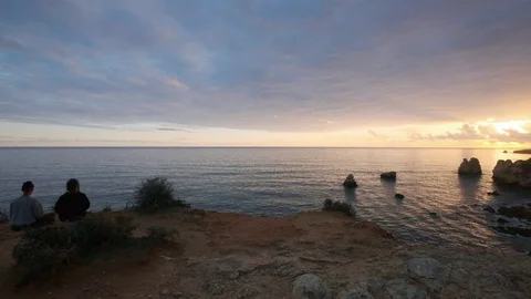 Couple watching sunset Stock Footage 128641934