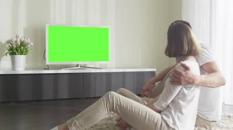 Couple Watching TV with Green Screen. Great for mockup usage. Stock Footage