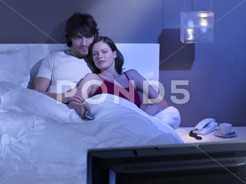 Couple watching tv. Stock Photos