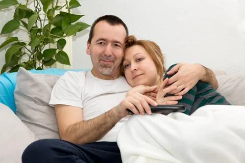 Couple watching tv on a sofa 写真素材