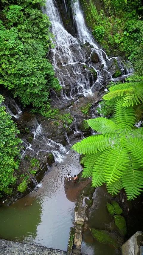 Couple in waterfall drone going up Stock Footage 240188557